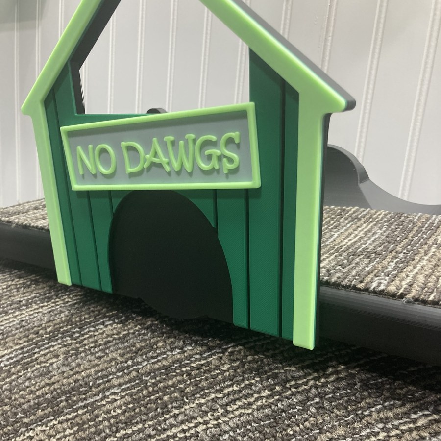 A Cozy Cat Pad installed at a No Dawgs cathouse entrance